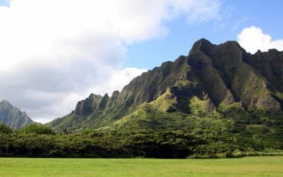 Green Ko'olau ridges rising above a grassy valley on O'ahu